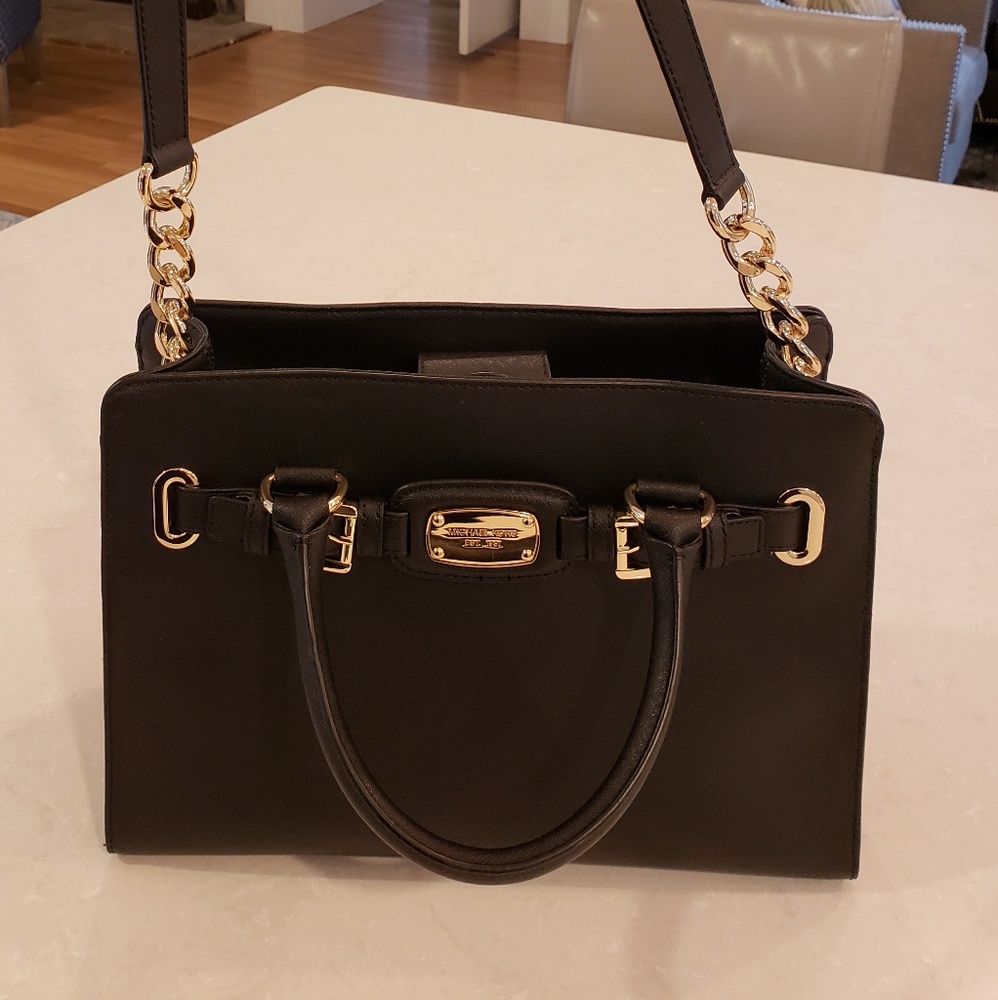 Michael Kors pocket book. New. Black. 12"x9"